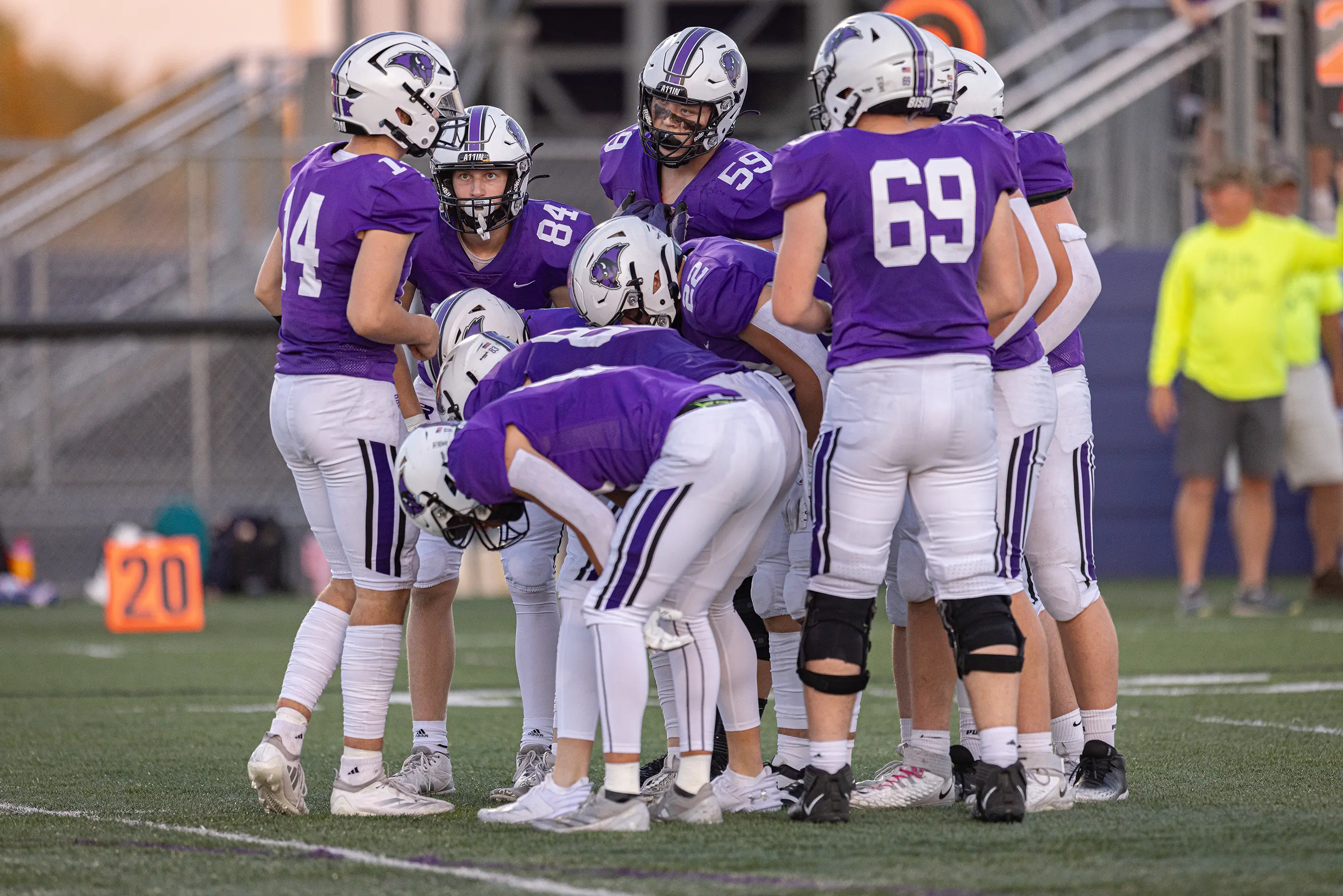 Offensive huddle getting the play from the QB