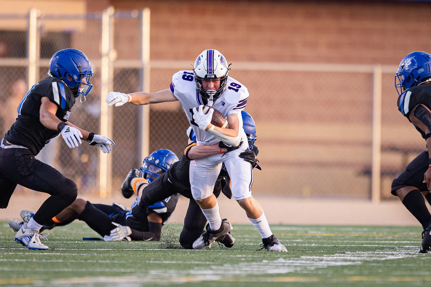 RB trying to shake defenders to gain more yards