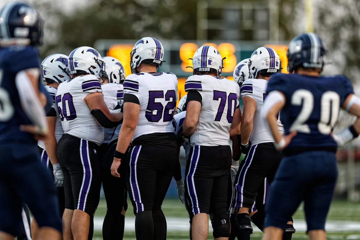 Offense in the huddle hearing the play